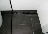 Tiled shower floor with custom grate