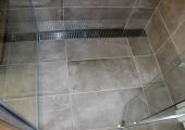 Tiled shower floor with custom grate