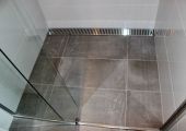 Tiled shower floor with custom grate